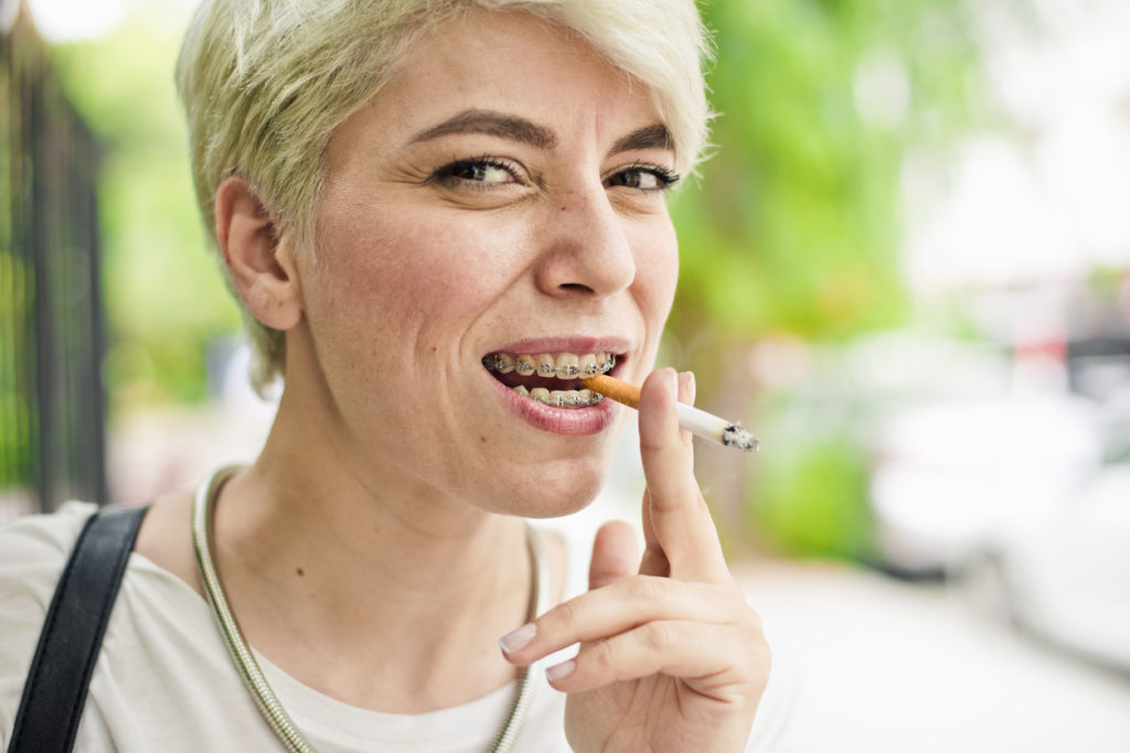 Person smoking with braces