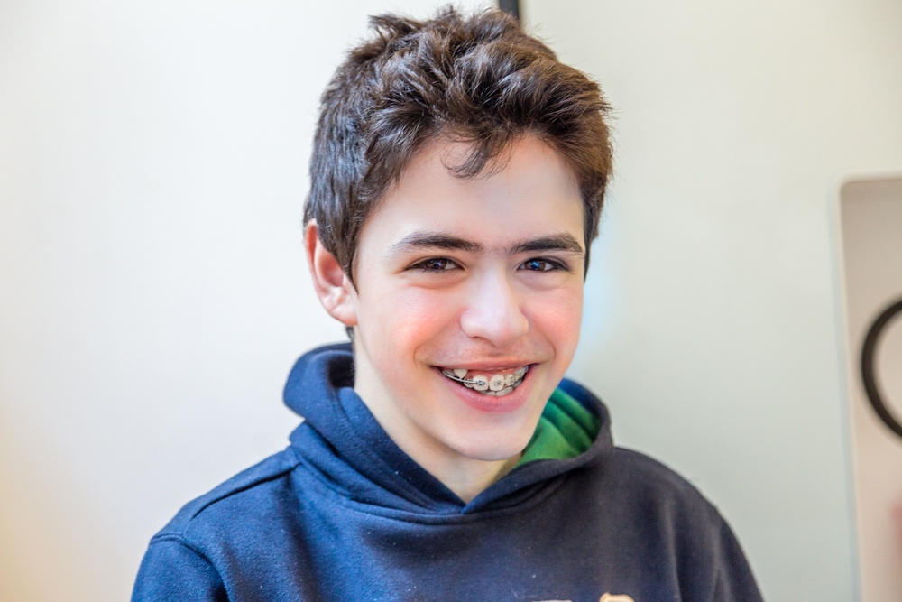 young teen with braces smiling in Kelowna BC