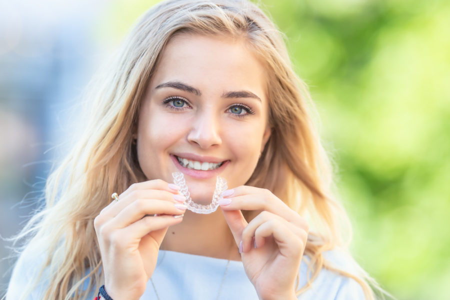 Young Attractive Woman Holding braces